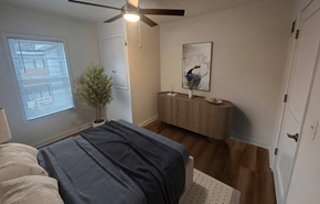 Madison apartment for rent - A bedroom with a bed, a ceiling fan, and a small tree.