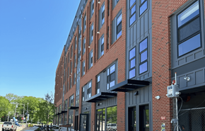 Madison apartment for rent - a red brick apartment building with gray and black facade