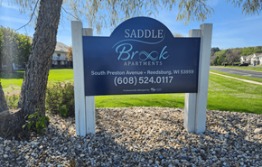 Reedsburg apartment for rent - A sign for Saddle Brook Apartments in Reedsburg, WI.