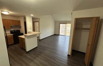 Reedsburg apartment for rent - A kitchen with a white counter and wooden cabinets.