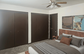 Marshall apartment for rent - A bedroom with a bed, pillows, and a ceiling fan.