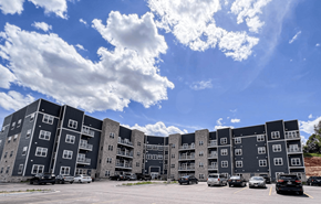 Wisconsin Dells apartment for rent - an apartment building in a parking lot under a cloudy sky