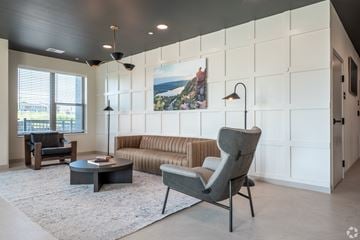 Madison apartment for rent - A modern living room with a grey chair and a white wall.