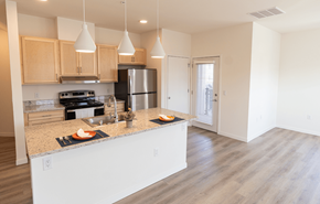 Madison apartment for rent - a kitchen with a large island and a stainless steel refrigerator