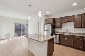 Brookfield apartment for rent - A kitchen with brown cabinets and a granite countertop.