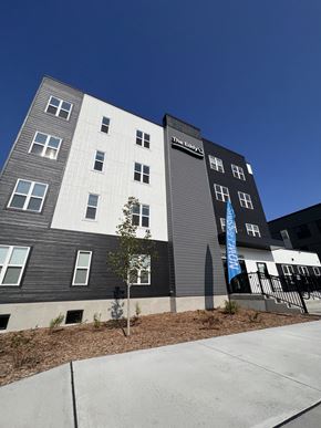 Eau Claire apartment for rent - a gray and white building with a blue sky in the background