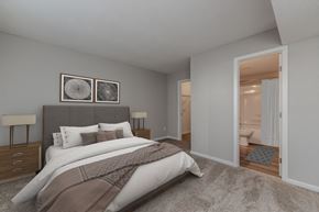 Virginia Beach apartment for rent - A bedroom with a large bed and two lamps.