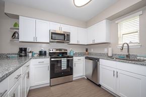 Newport News apartment for rent - newly renovated kitchen with white cabinets, stainless steel appliances, and granite countertops