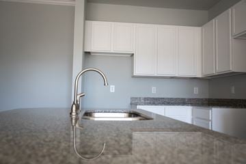 Sanford apartment for rent - A kitchen sink with a faucet and a countertop.