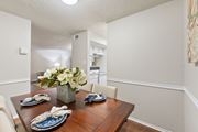 Temple apartment for rent - Dining room with wood table and place settings at Parks on the Green Apartments, Temple, TX 76504