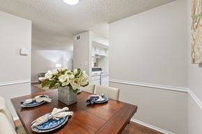 Temple apartment for rent - Dining room with wood table and place settings at Parks on the Green Apartments, Temple, TX 76504