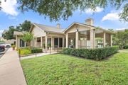 Temple apartment for rent - Clubhouse building with covered porch and landscaping at Parks on the Green Apartments, Texas