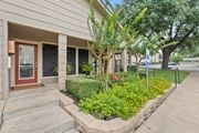 Temple apartment for rent - Building entrance with landscaped garden and flowers at Parks on the Green Apartments, Temple, Texas