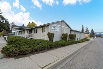 Newport apartment for rent - a white building with a sign on it on the side of a street