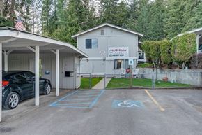 Priest River apartment for rent - a parking lot with a car parked in front of a house