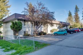 Newport apartment for rent - a white building with cars parked in front of it
