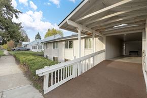 Newport apartment for rent - a white porch with a white railing in front of a white house