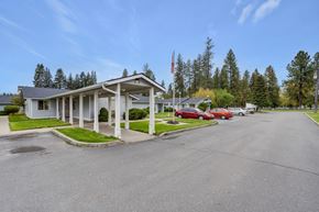 Deer Park apartment for rent - a white motel with cars parked in front of it