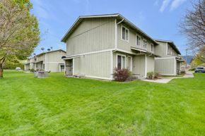 Chewelah apartment for rent - a row of houses with green grass and a sidewalk