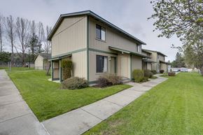 Newport apartment for rent - a green and tan house with a sidewalk in front of it