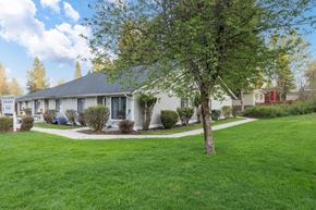 Newport apartment for rent - a white house with a yard and a tree