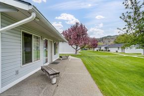 Kettle Falls apartment for rent - the side of a house with a walkway and a bench