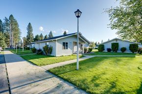 Rathdrum apartment for rent - a white house with a lamp post on the side of a sidewalk