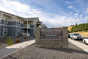 Pendleton apartment for rent - Wildflower Apartments sign in front of a building.