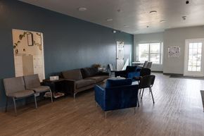 Pendleton apartment for rent - A living room with a grey couch, a blue couch, and a brown chair.