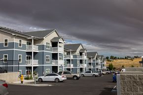 Pendleton apartment for rent - A row of apartment buildings with cars parked in front.