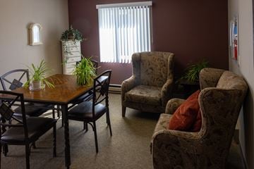 Joseph apartment for rent - a living room with a dining room table and chairs