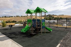 Pendleton apartment for rent - A playground with a green slide and a green roofed structure.