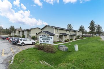 Newport apartment for rent - a building with a sign in front of a parking lot