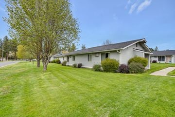 Deer Park apartment for rent - a white house on the side of a street with a lawn and trees