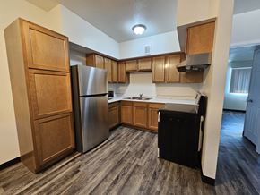 Huachuca City apartment for rent - A kitchen with a refrigerator, sink, and cabinets.