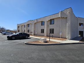 Huachuca City apartment for rent - A black car is parked in a parking lot in front of a building.