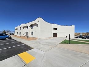 Huachuca City apartment for rent - A white building with a parking lot in front.
