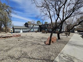 Cottonwood apartment for rent - A large grey building with a tree in front of it.