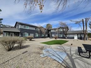 Cottonwood apartment for rent - A grey building with a green lawn in front.