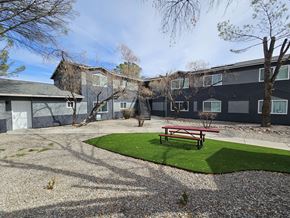 Cottonwood apartment for rent - A building with a grey roof and a red bench in front of it.