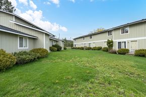 Newport apartment for rent - a row of houses with a green lawn and a blue sky