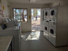Eloy apartment for rent - A laundromat with a view of the outside through the window.