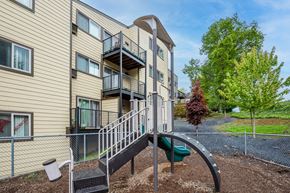 St.Helens apartment for rent - A playground with a slide is in front of a building.