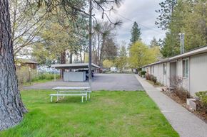 Priest River apartment for rent - A park with a bench and a pathway.
