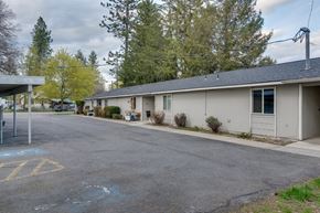 Priest River apartment for rent - A parking lot with a yellow no parking sign painted on the pavement.