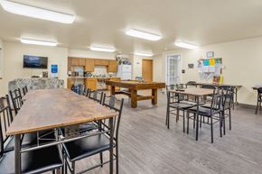 Grants Pass apartment for rent - a dining room with tables and chairs and a kitchen