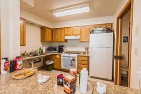 Jacksonville apartment for rent - a kitchen with a counter with food and a refrigerator