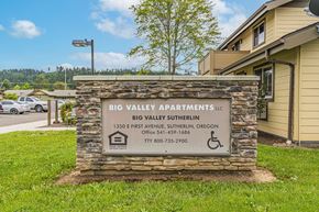 Sutherlin apartment for rent - a building with a sign for big valley apartments