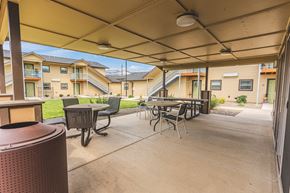 Phoenix apartment for rent - A patio with a table and chairs under a canopy.
