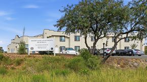 Huachuca City apartment for rent - A building with a sign that says Desert Sage Apartments.